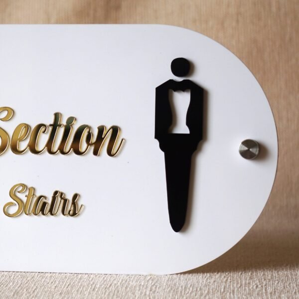 Detailed close-up of the black male tuxedo icon on the premium 'Male Section' store sign.