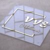 Close-up of a luxury 3D gold letter acrylic sign, emphasizing the clean edges and reflective quality of the metallic "VVS Moments..." text.