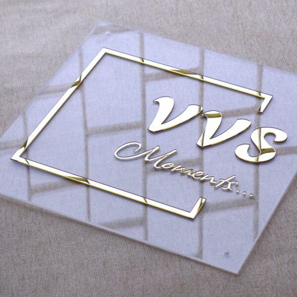Close-up of a luxury 3D gold letter acrylic sign, emphasizing the clean edges and reflective quality of the metallic "VVS Moments..." text.