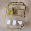 Top-down view of the personalized wedding thumbprint keepsake, showing the full curly frame design, gold lettering, and blank white spaces for the couple's prints.