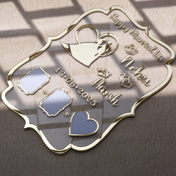 Angled view of a personalized gold acrylic wedding keepsake for couples, showing the 3D lettering and reflective mirror finish on the thumbprint spots.