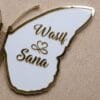 Close-up on the right wing of a butterfly nikah board, showcasing the elegant custom names 'Wasif & Sana' in golden script on a white background.