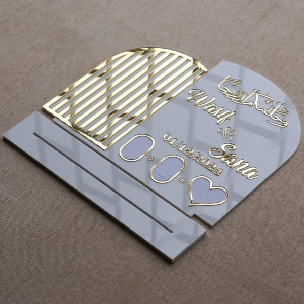 The Nikah thumb board disassembled and laid flat, showing the main plaque with gold details and the separate slotted stand from a high angle.