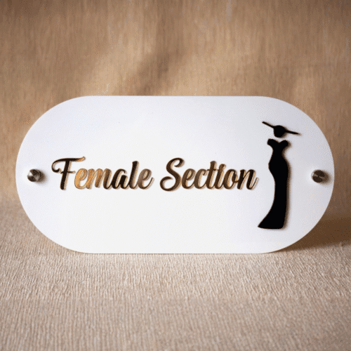 Professional 'Female Section' signage in white acrylic with gold text and a black female silhouette icon for retail stores.