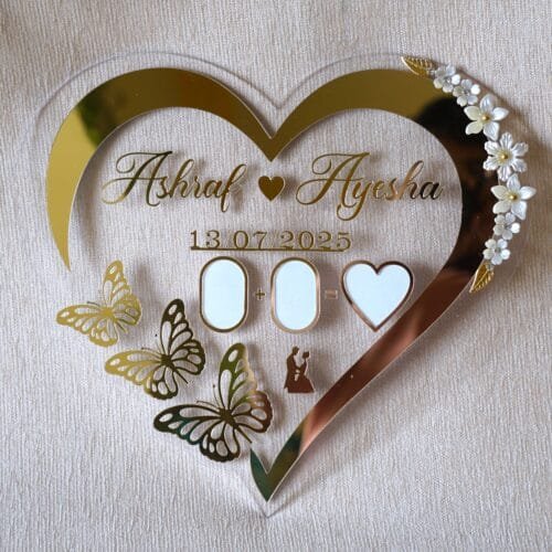 Full front view of a heart-shaped acrylic Nikah thumb board, personalized with the names 'Ashraf & Ayesha' and a date.