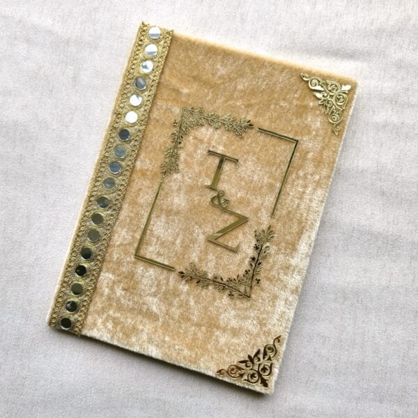 20250721_141159 Angled view of the luxurious golden velvet Nikah certificate cover, highlighting the shimmering mirror lace on the spine.