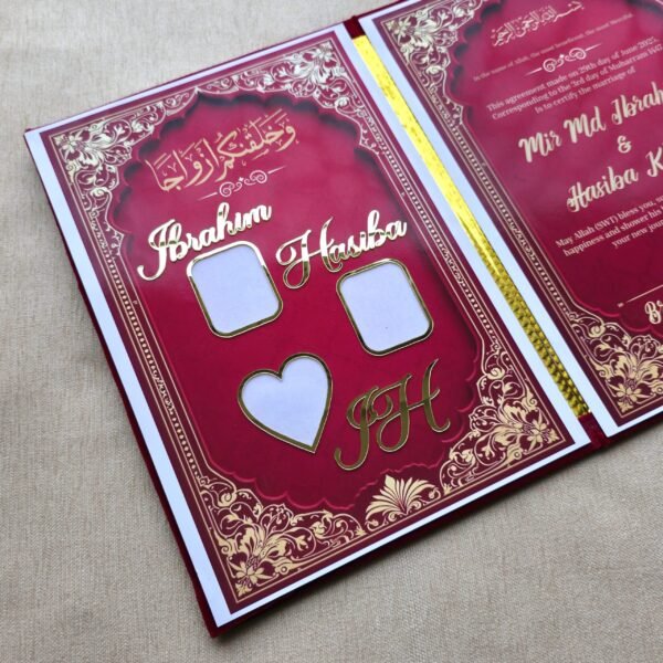 Angled perspective shot of the open Nikah Nama booklet, displaying the custom gold names and the marriage agreement page.