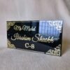 20250830_153256 Angled view of the black and gold acrylic nameplate showing the glossy, reflective surface and 3D embossed text.