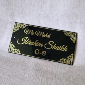20250830_153500 Close-up shot of the elegant black acrylic door sign with custom golden lettering, highlighting the intricate corner details.