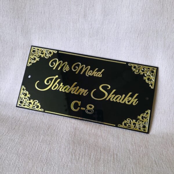 20250830_153500 Close-up shot of the elegant black acrylic door sign with custom golden lettering, highlighting the intricate corner details.