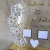 Angled shot of the personalized acrylic Nikah thumb board, highlighting the shimmer of the gold names and the elegant pearl frame against a neutral background.
