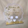 20250919_143150 Front view of a personalized acrylic Nikah thumb board with a pearl frame, gold lettering, and white floral details, standing upright on its gold base.