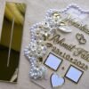 20250919_143620 Close-up angle of the personalized Nikah thumb board, showing the 3D texture of the gold acrylic names and the intricate details of the floral and pearl embellishments.