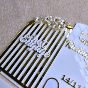 A close-up angle of the 'Just Engaged' text and floral embellishments on the personalised acrylic thumb board.