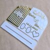 A disassembled view of the personalised engagement plaque and its white acrylic stand on a neutral background.