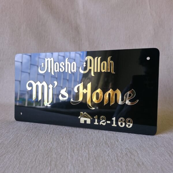 Angled perspective of the black and gold Mashallah nameplate, highlighting the reflective quality of the golden letters.