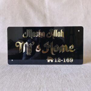 Direct front-on view of the Mashallah nameplate showing a clear reflection in the golden 'MJ's Home' text.