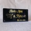 Front view of the Mashallah acrylic nameplate with 3D embossed golden lettering on a textured white background.