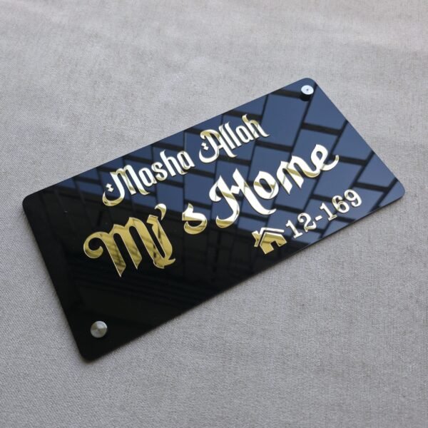 Angled view from the top right of the black acrylic nameplate with golden calligraphy and silver wall mounts.