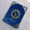An angled perspective of the personalized royal blue velvet Nikah Nama booklet, showing the 3D effect of the gold acrylic lettering.