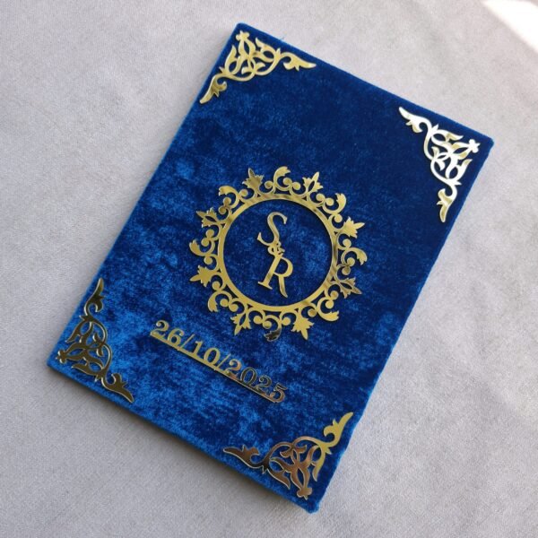 An angled perspective of the personalized royal blue velvet Nikah Nama booklet, showing the 3D effect of the gold acrylic lettering.