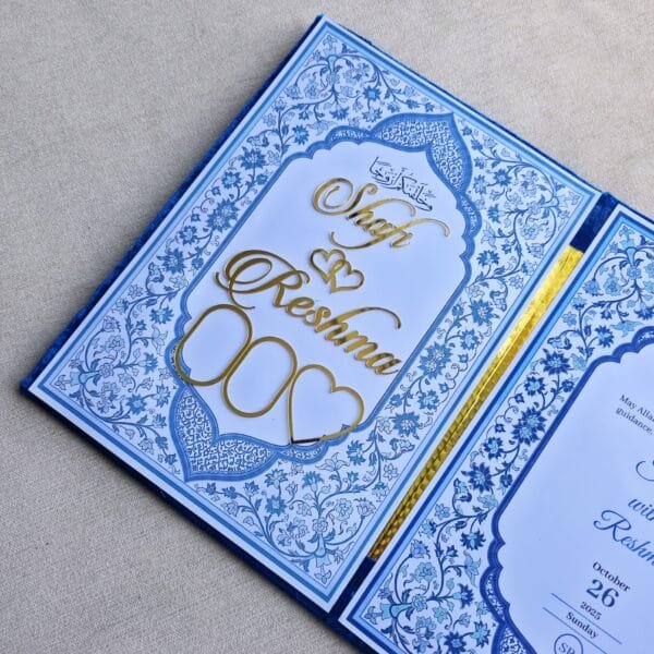 The inside left panel of the Nikah Nama booklet featuring gold acrylic names 'Shafi' and 'Reshma' with two empty heart-shaped slots for photos.